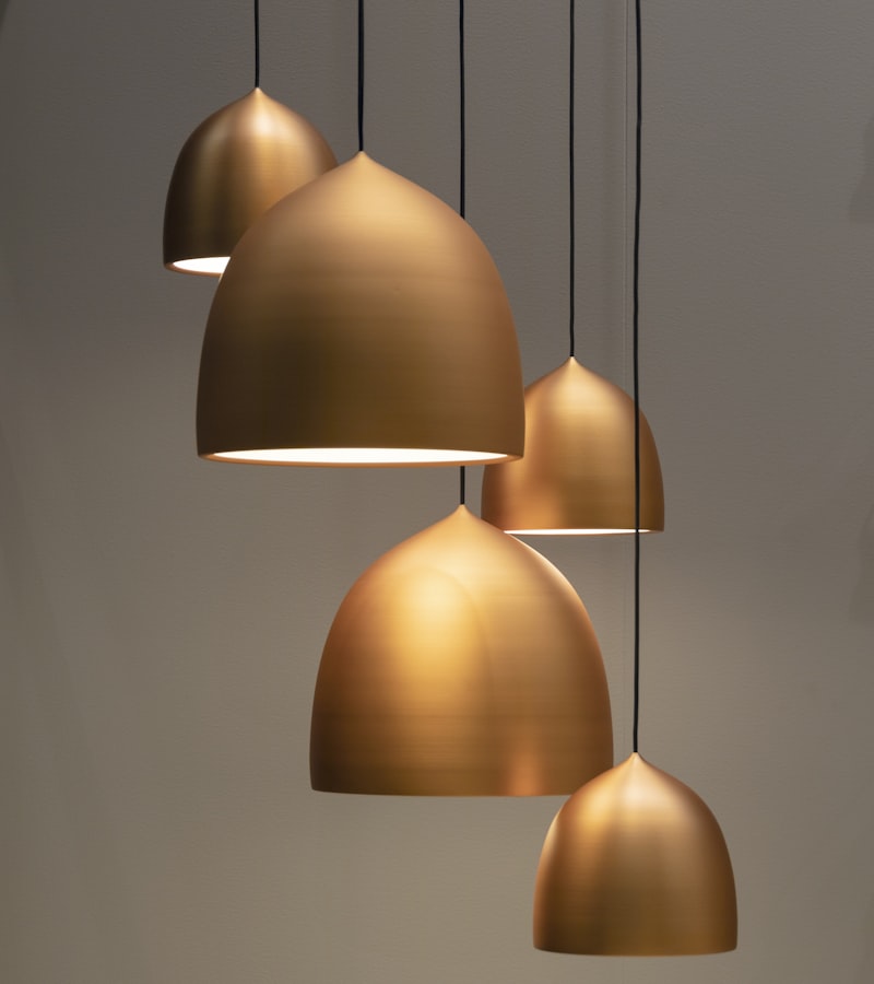 A row of brass pendant lamps above a counter