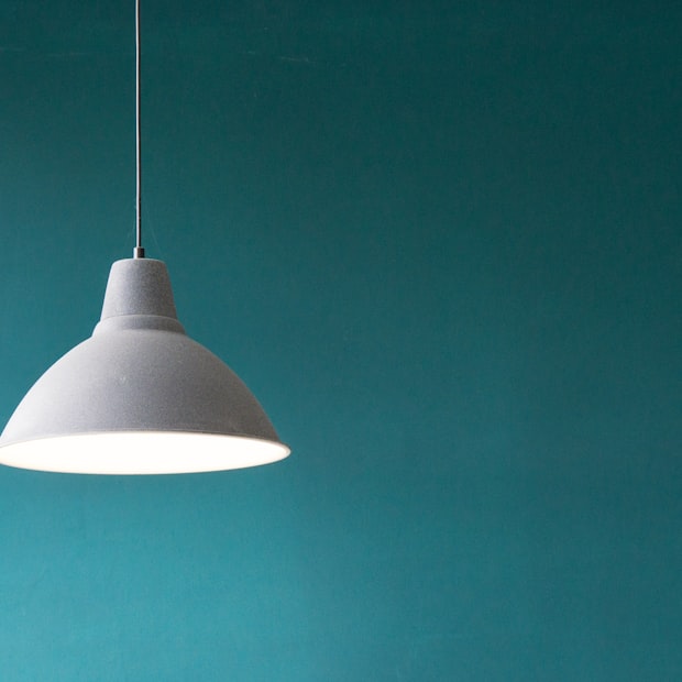 A white dome pendant lamp hanging from a cord