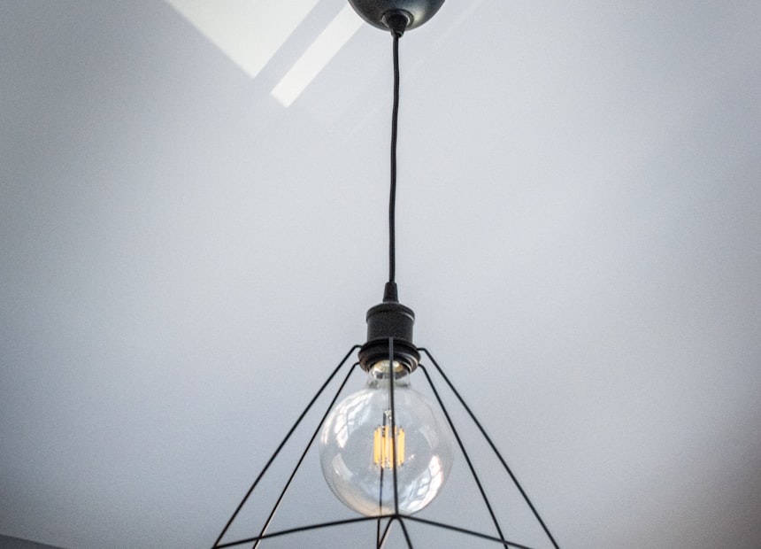 A geometric cage pendant with an exposed bulb